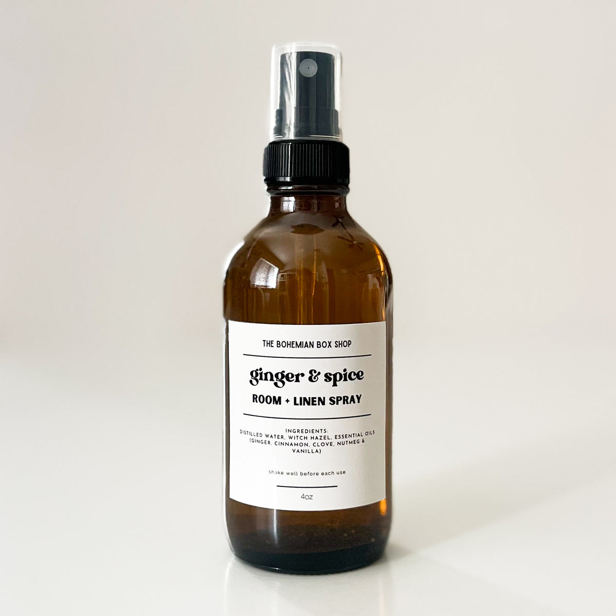 ginger and spice amber glass spray bottle with a label on a light background