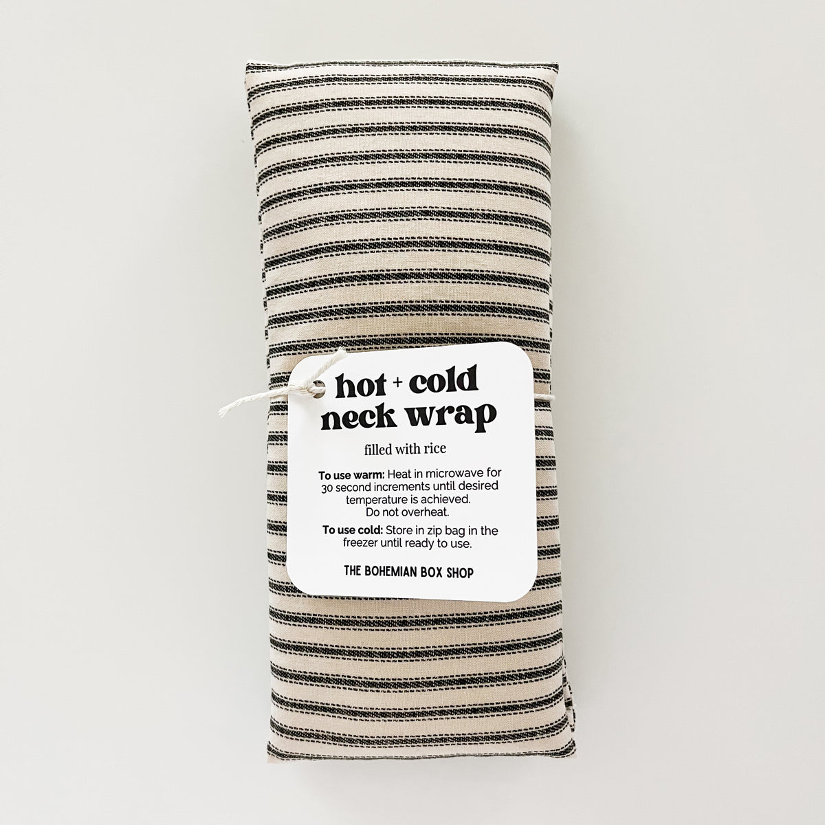 Hot and Cold Neck Wrap filled with rice and an ivory and black fabric.