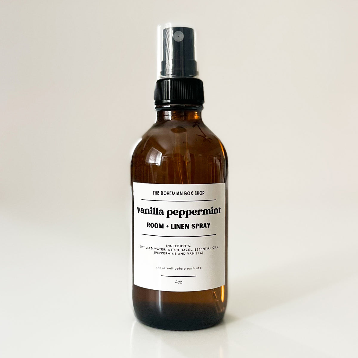 Vanilla peppermint room linen spray bottle with label on a white background