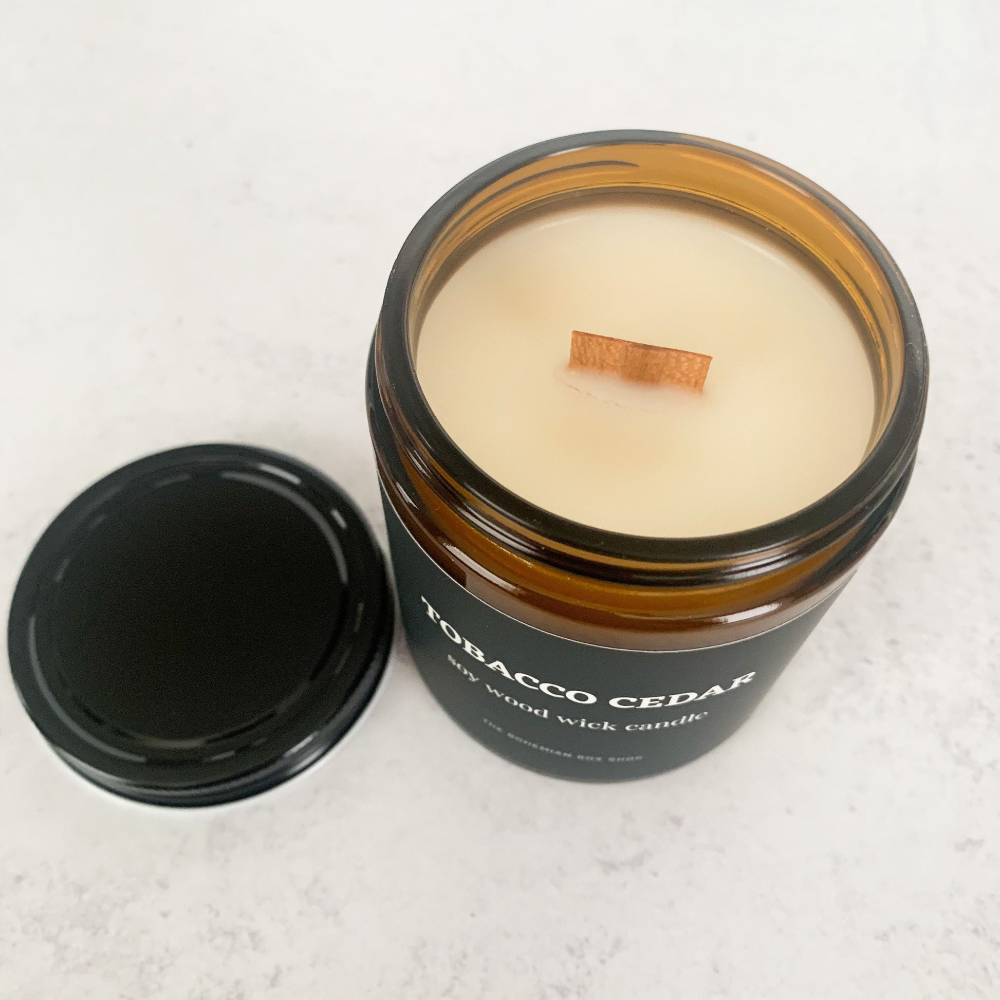 Tobacco Cedar 8oz Amber Jar Soy Candle with black lid and wood wick 