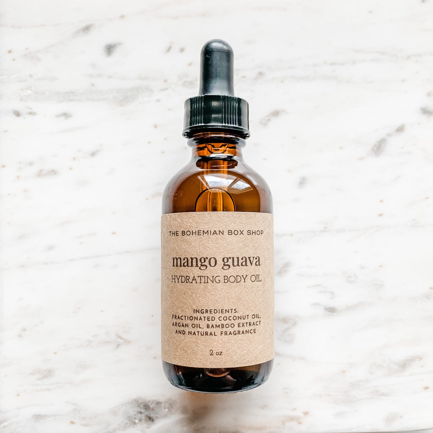 Mango Guava Hydrating Body Oil in an amber colored bottle with black dropper