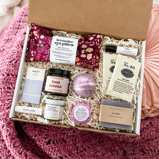 Purple Care package for any Mom. Contains lavender eye pillow, chocolate bar, French vanilla lip balm, best mama soy candle, hand scrub, bath bomb, shower steamer, tea packets, relax roller bottle, and lavender soap. ￼
