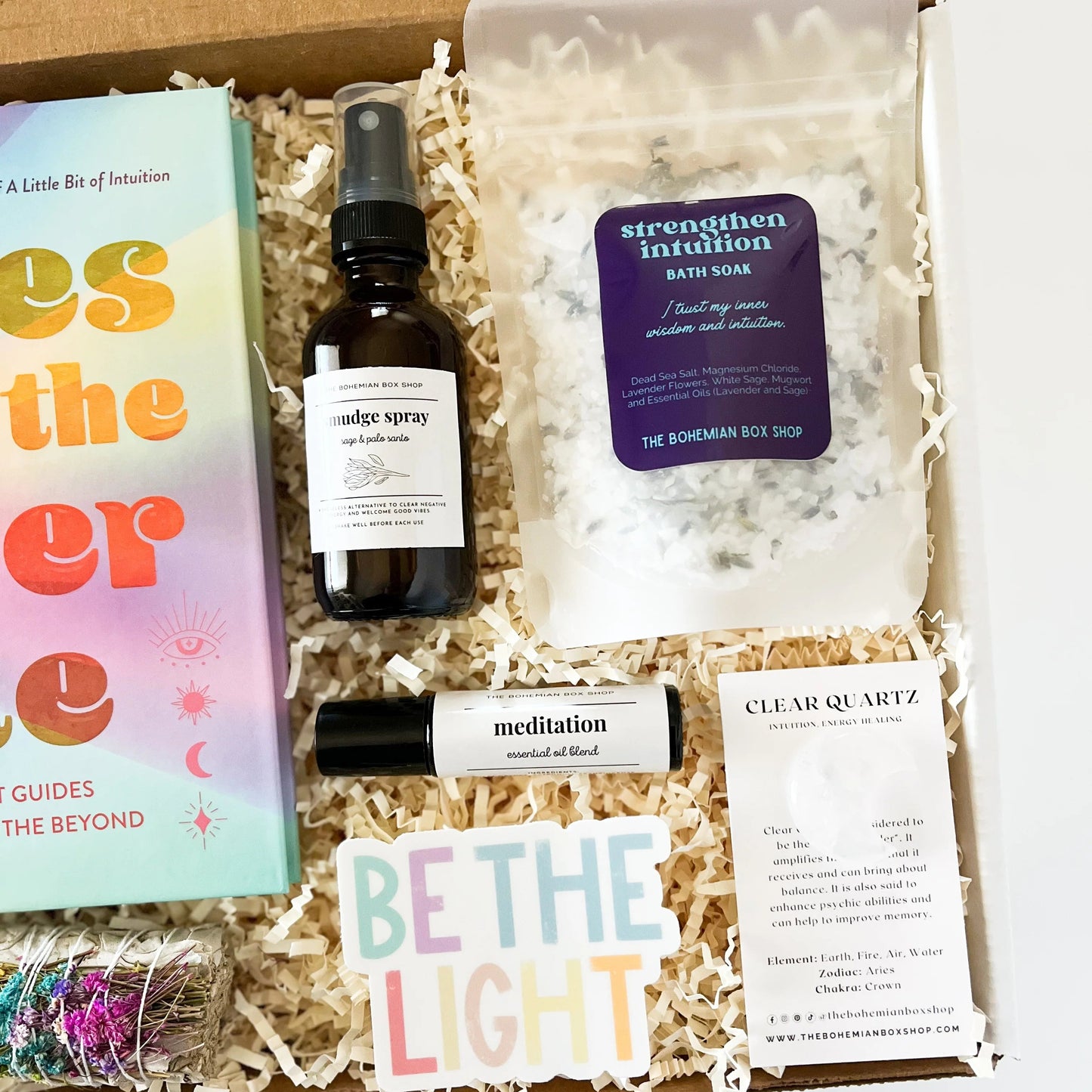 Be the light gift set. Includes vibes from the other side book, sage bundle, smudge spray, meditation roller bottle, be the light sticker, intuition bath soak, and clear quartz moon crystal. 
