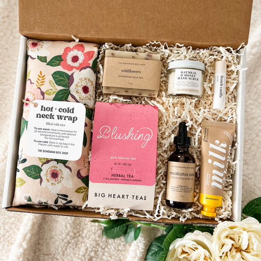 Ultimate spa gift set containing hot and cold neck wrap, wildflowers soap bar, blushing tea, oatmeal and honey hand scrub, eucalyptus mint body oil, French vanilla lip balm, milk and honey hand cream. 