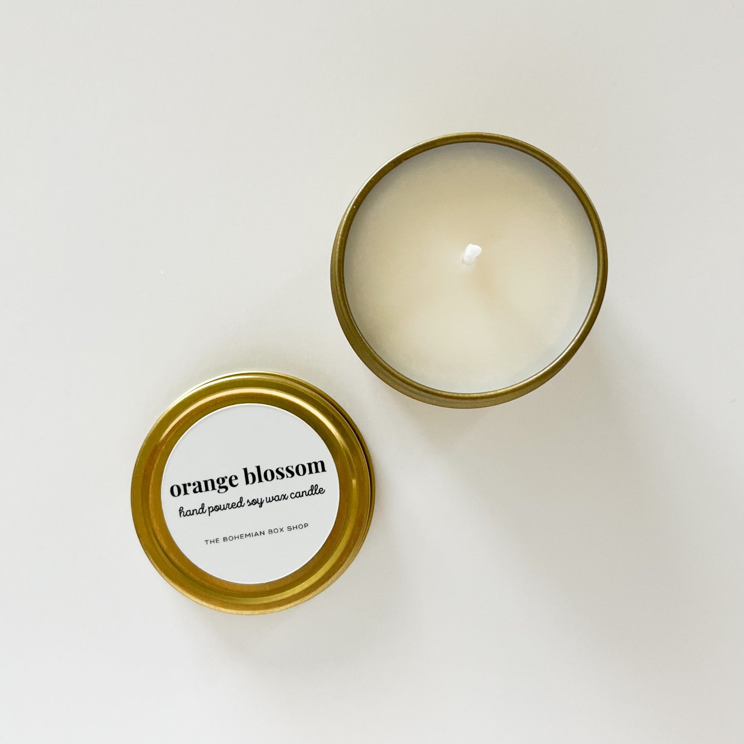 Orange blossom soy candle in a gold tin.