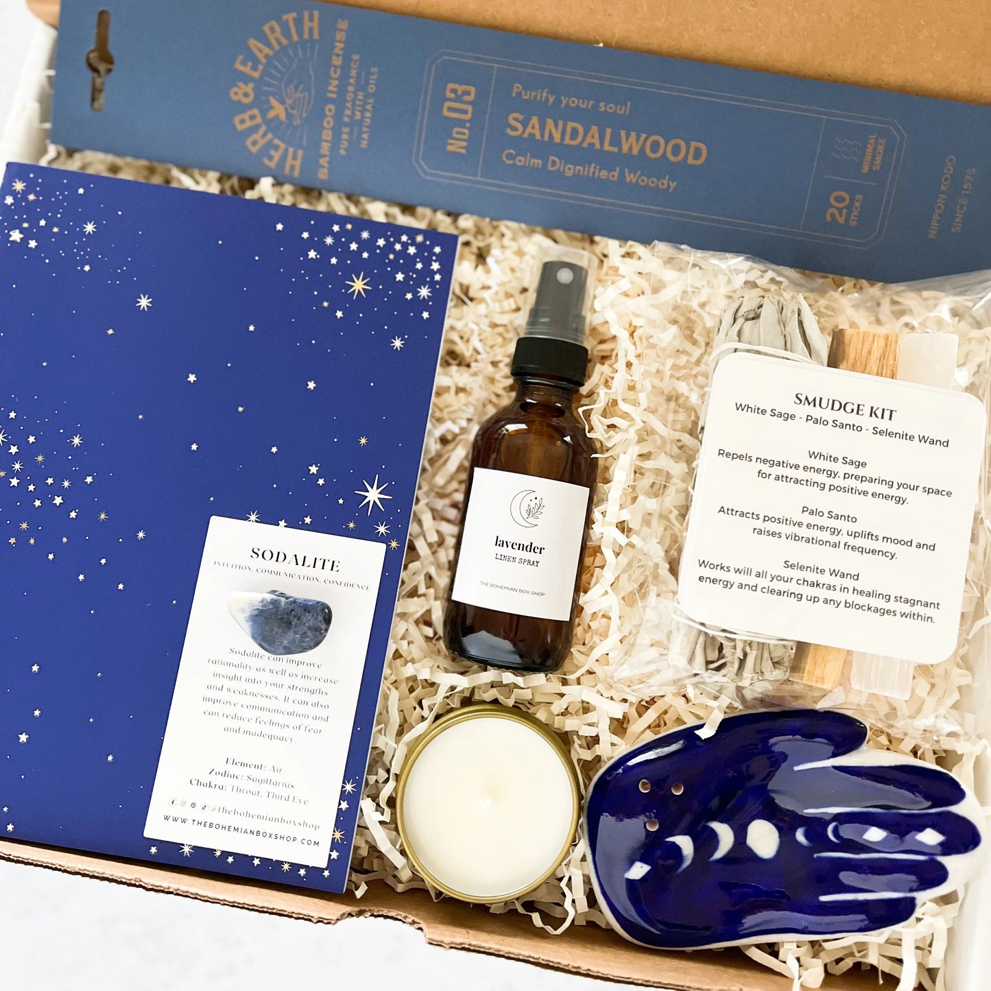 Celestial Spiritual Gift Set Box - Energy Cleansing Kit. Includes incense and hamsa holder, blue celestial journal, sodalite, lavender linen spray, soy candle, and smudge kit. 