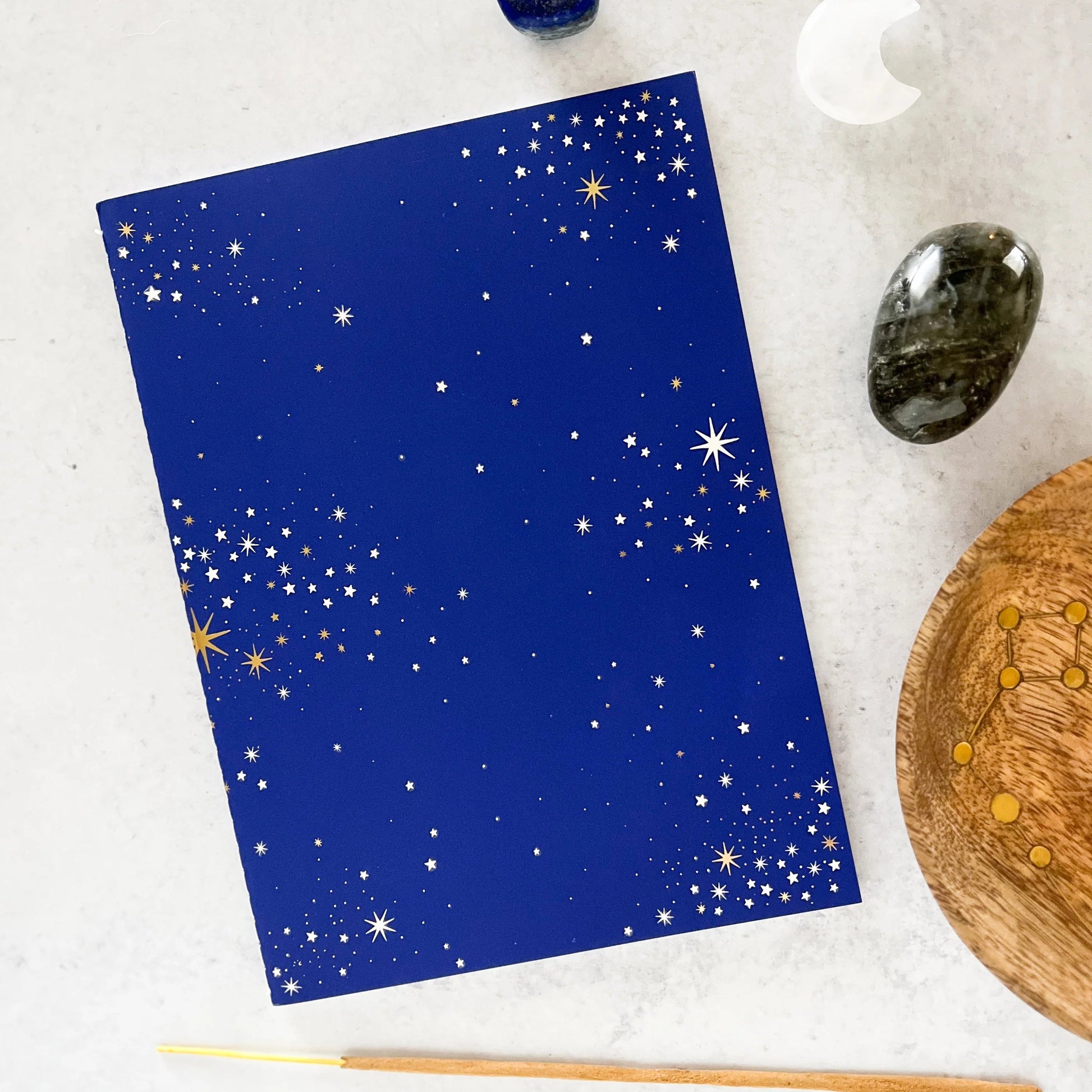 Dark blue celestial journal with white and gold stars 