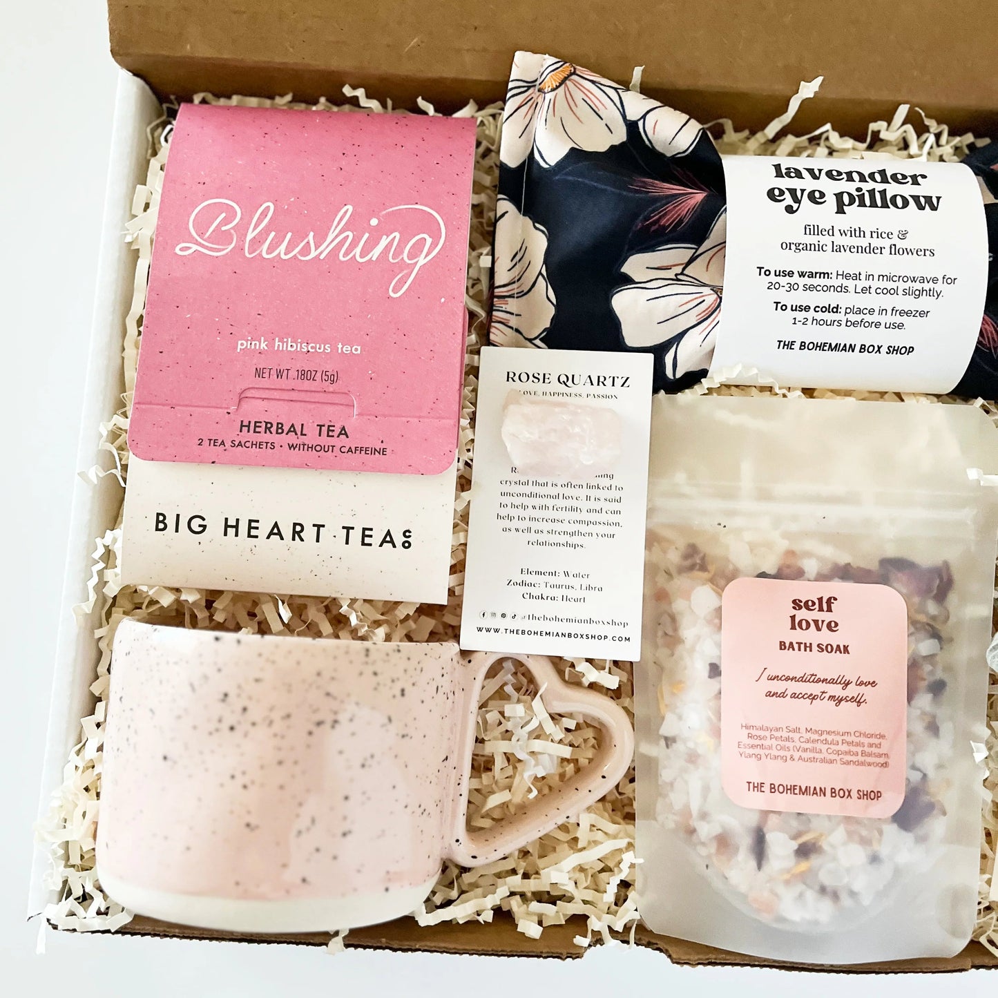 Self-love care package for her. Contains blushing tea, heart shaped mug, rose quartz crystal, lavender eye pillow, self-love bath soak with affirmation and mini sage bundle. 