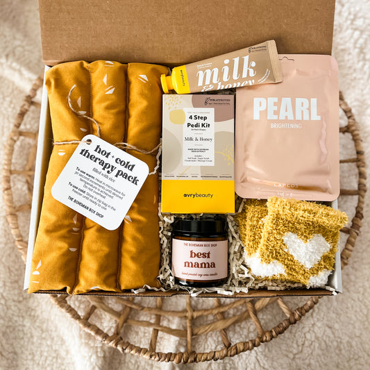 Gift set for the best mama containing hot and cold therapy pack, best mama soy candle, four step pedi kit, milk and honey hand lotion, pearl facial mask and mustard yellow heart socks . ￼