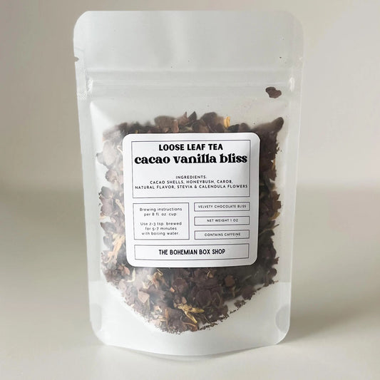 Loose leaf tea package labeled 'cacao vanilla bliss' from The Bohemian Box Shop on a light background
