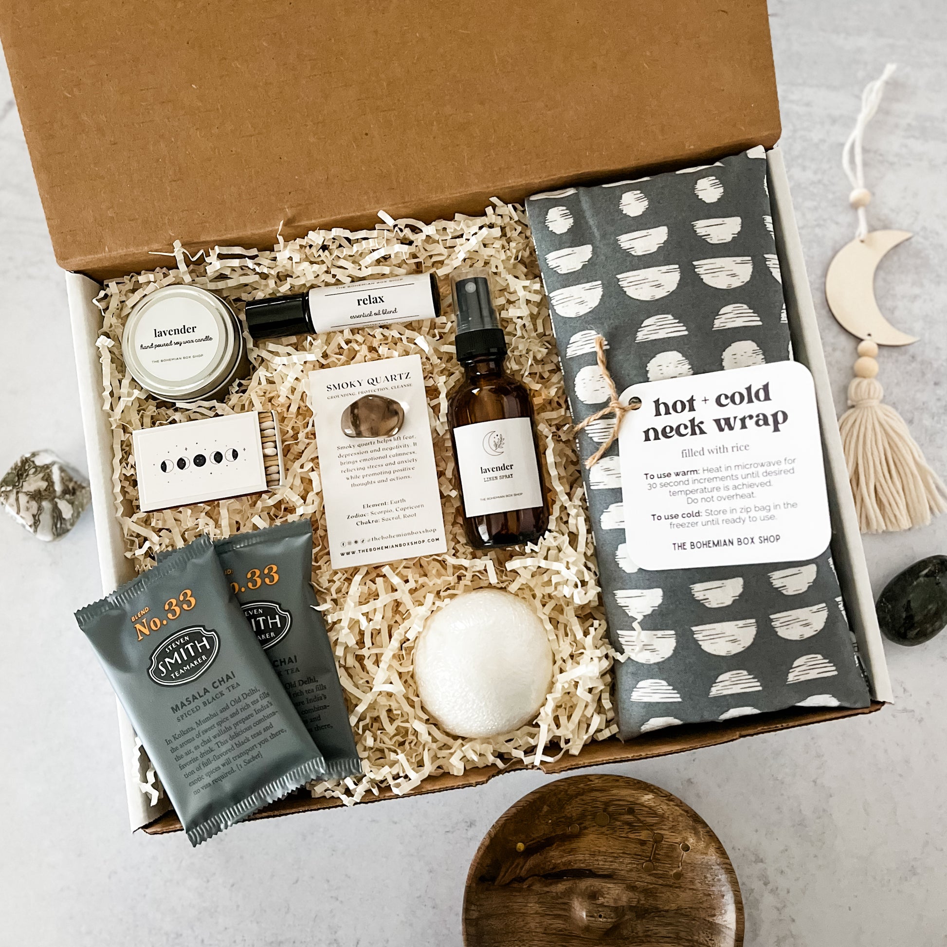 Gender Neutral Moon Spa Gift Set. Includes a soy candle, moon matchbox, tea packets, roller bottle, smoky quartz crystal, lavender linen spray, bath bomb and moon pattern hot and cold neck wrap.