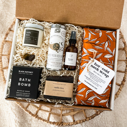 Thinking of you gift basket, containing a candle, tigers eye crystal, bath bomb tea, lavender linen spray, vanilla clove soap, and hot and cold neck wrap.￼