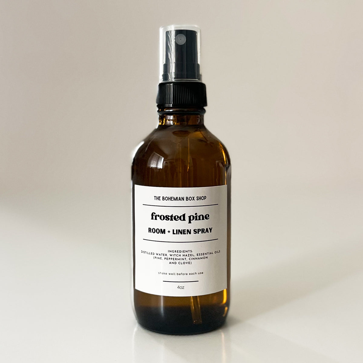 frosted pine room and linen spray bottle labeled 'frosted pine' on a light background