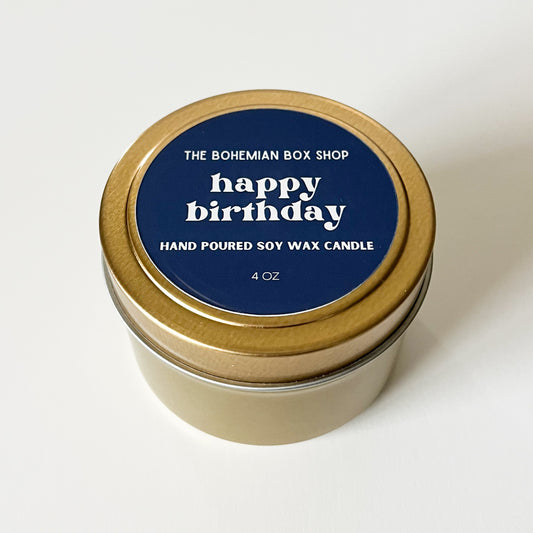 Hand poured soy wax candle in a gold tin with a blue label from The Bohemian Box Shop on a white background