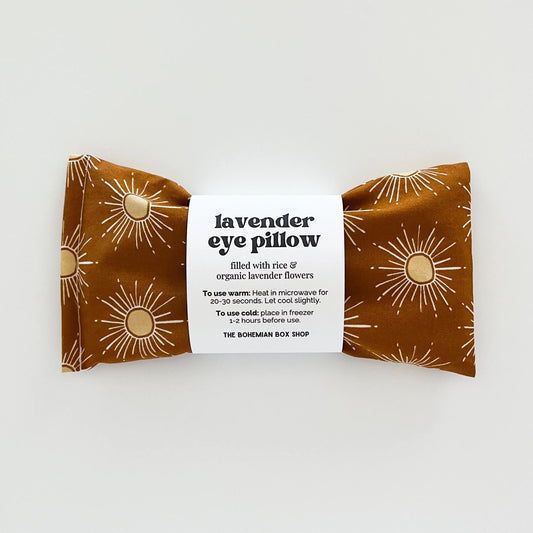 Lavender eye pillow with sun pattern packaging on a white background
