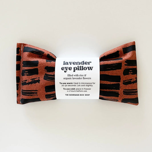 Lavender eye pillow with brown and black pattern on a white background