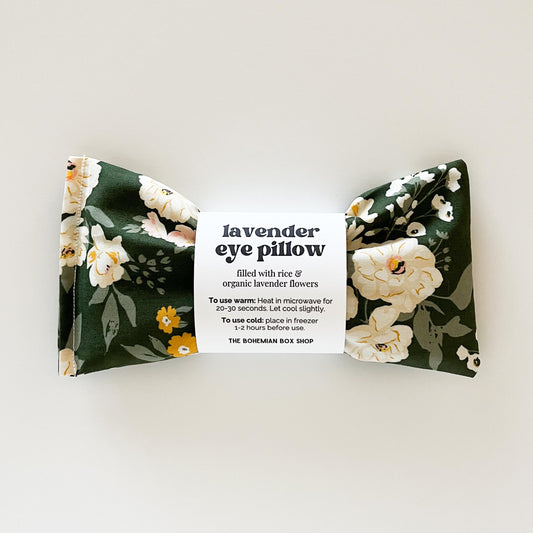 Lavender eye pillow with green background and yellow and white flowers on a white background