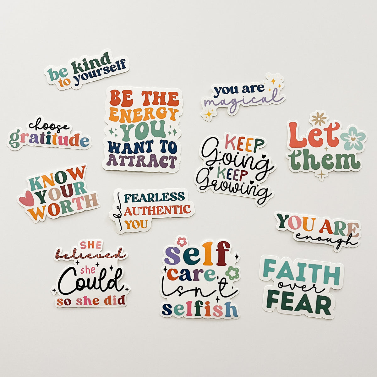 assorted colorful boho stickers with uplifting phrases on a white background