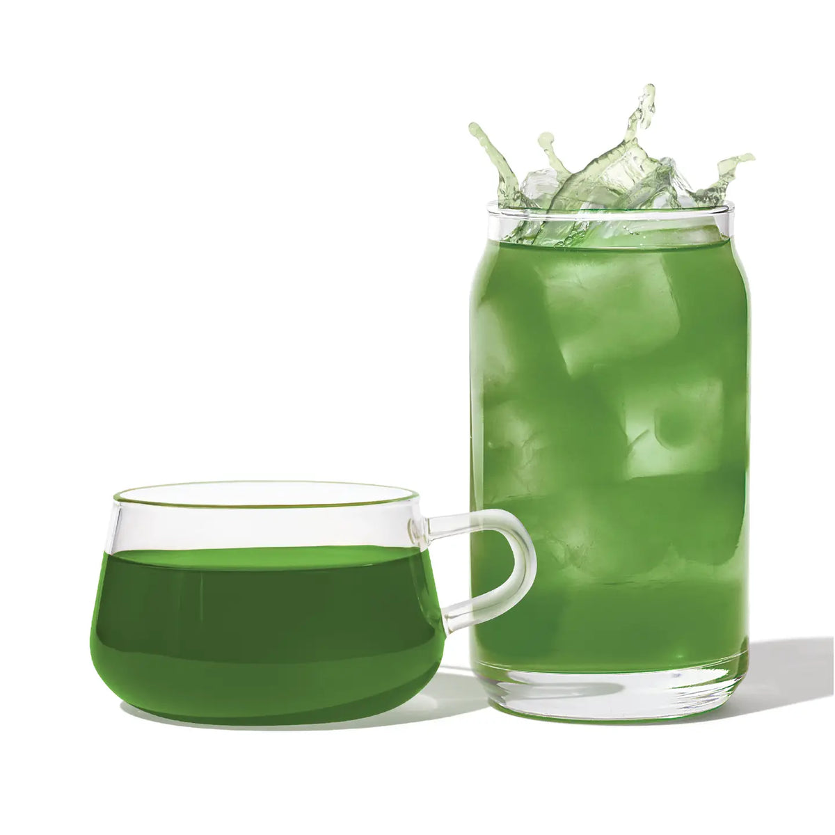 Two glasses filled with green tea on a white background