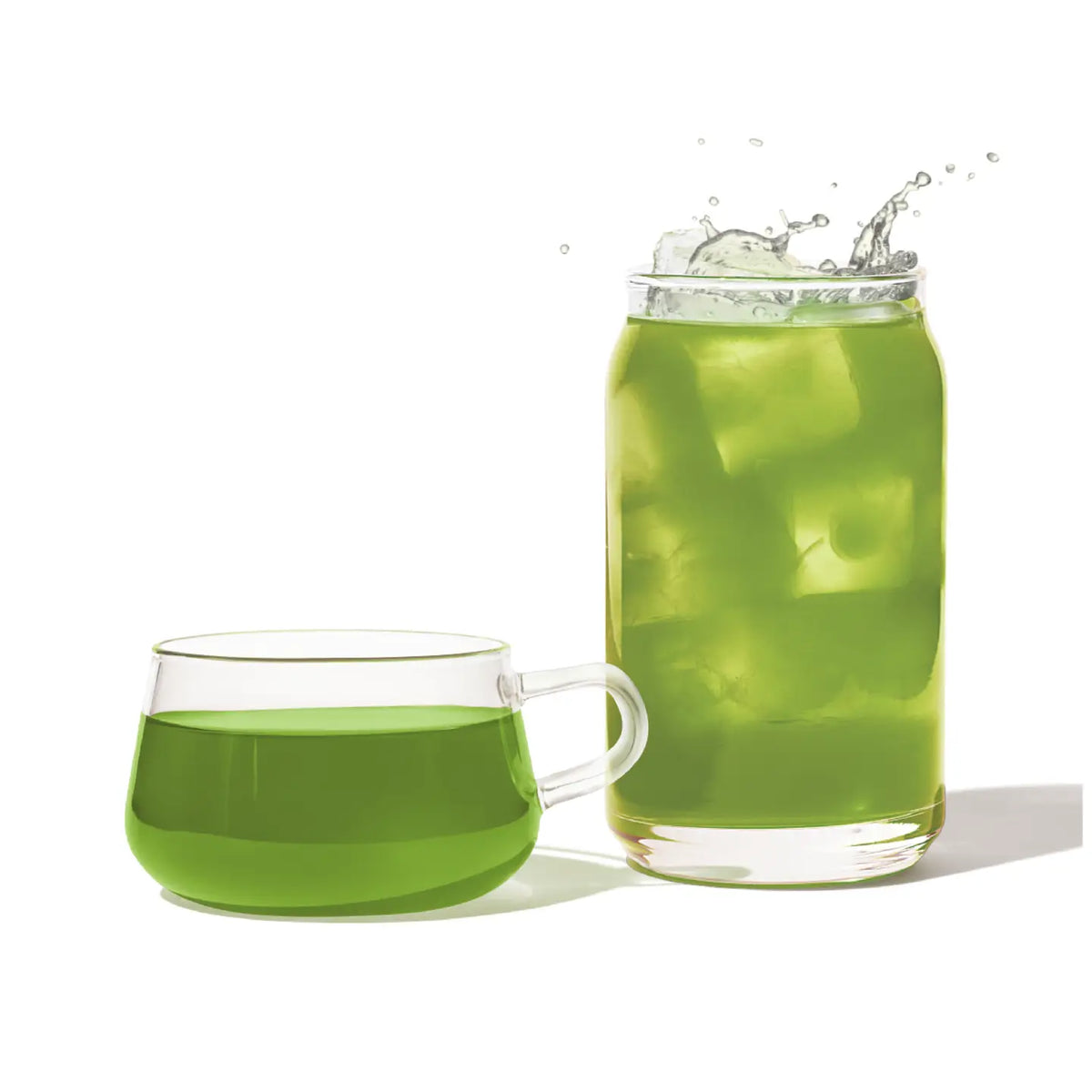 Green tea in a glass mug and glass on a white background