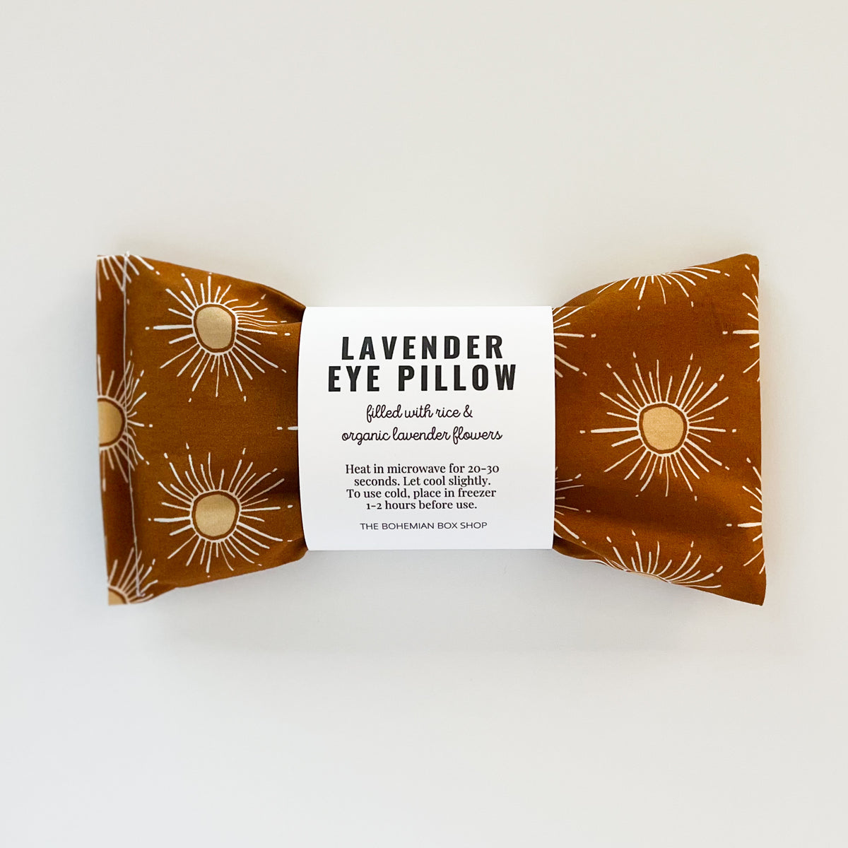 Lavender eye pillow packaging with sun design on a white background