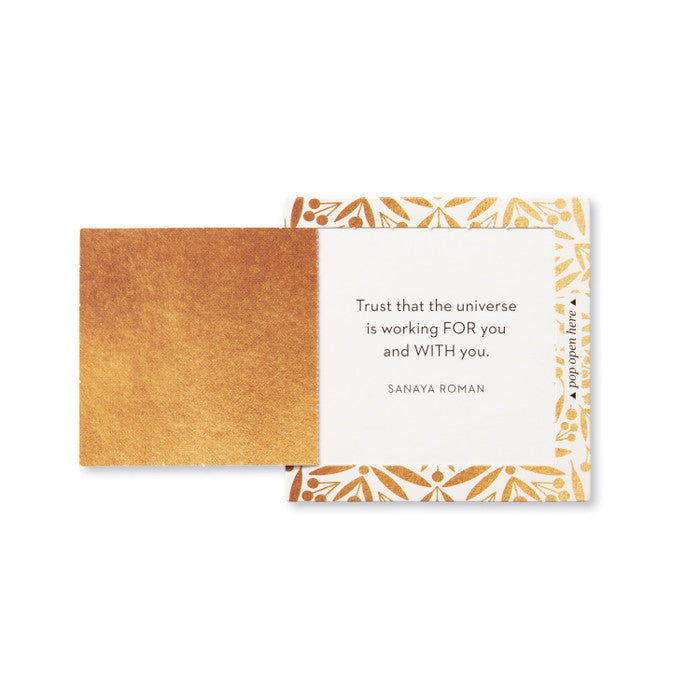 Motivational card with gold and white design and quote on a white background