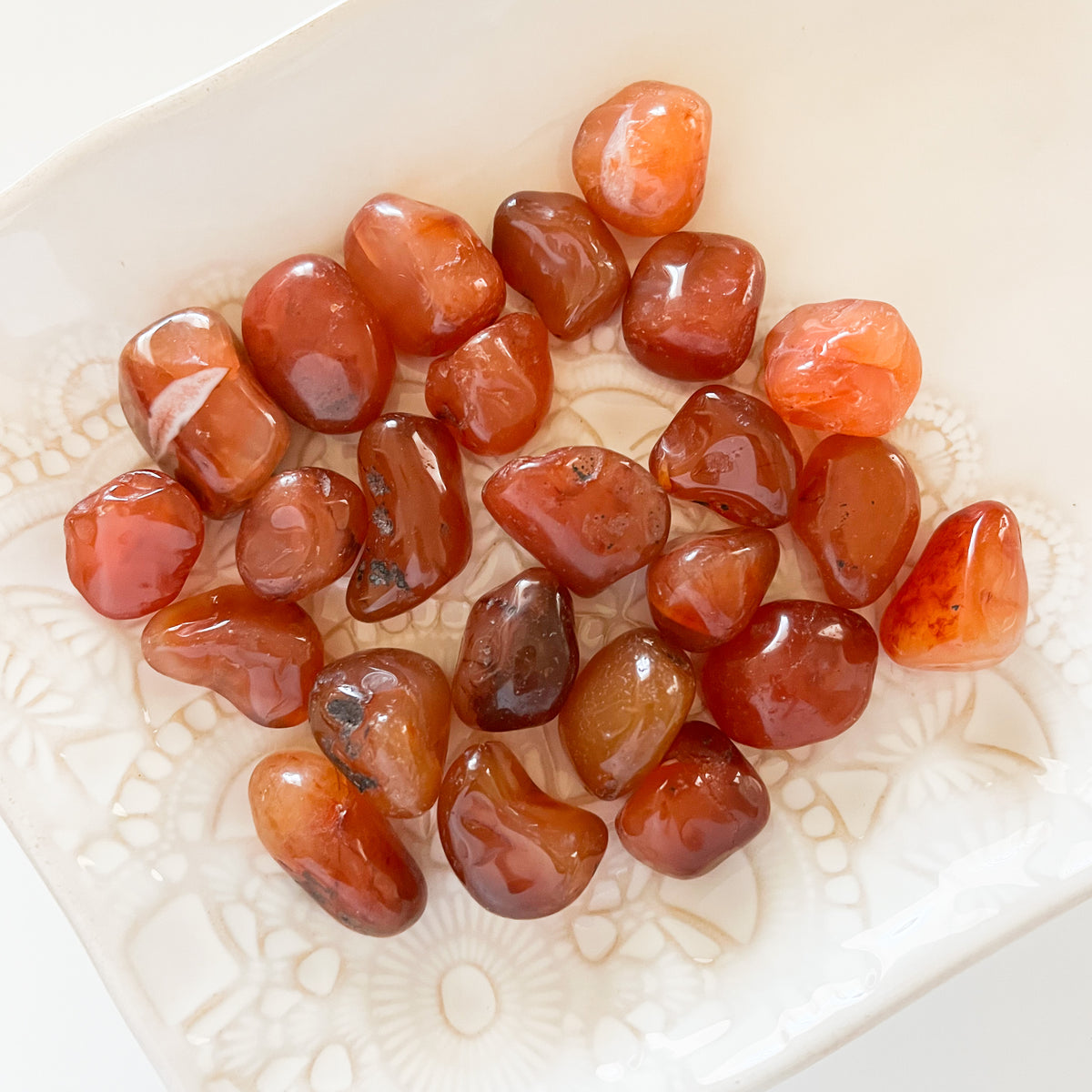 Carnelian Tumbled cystals on a plate