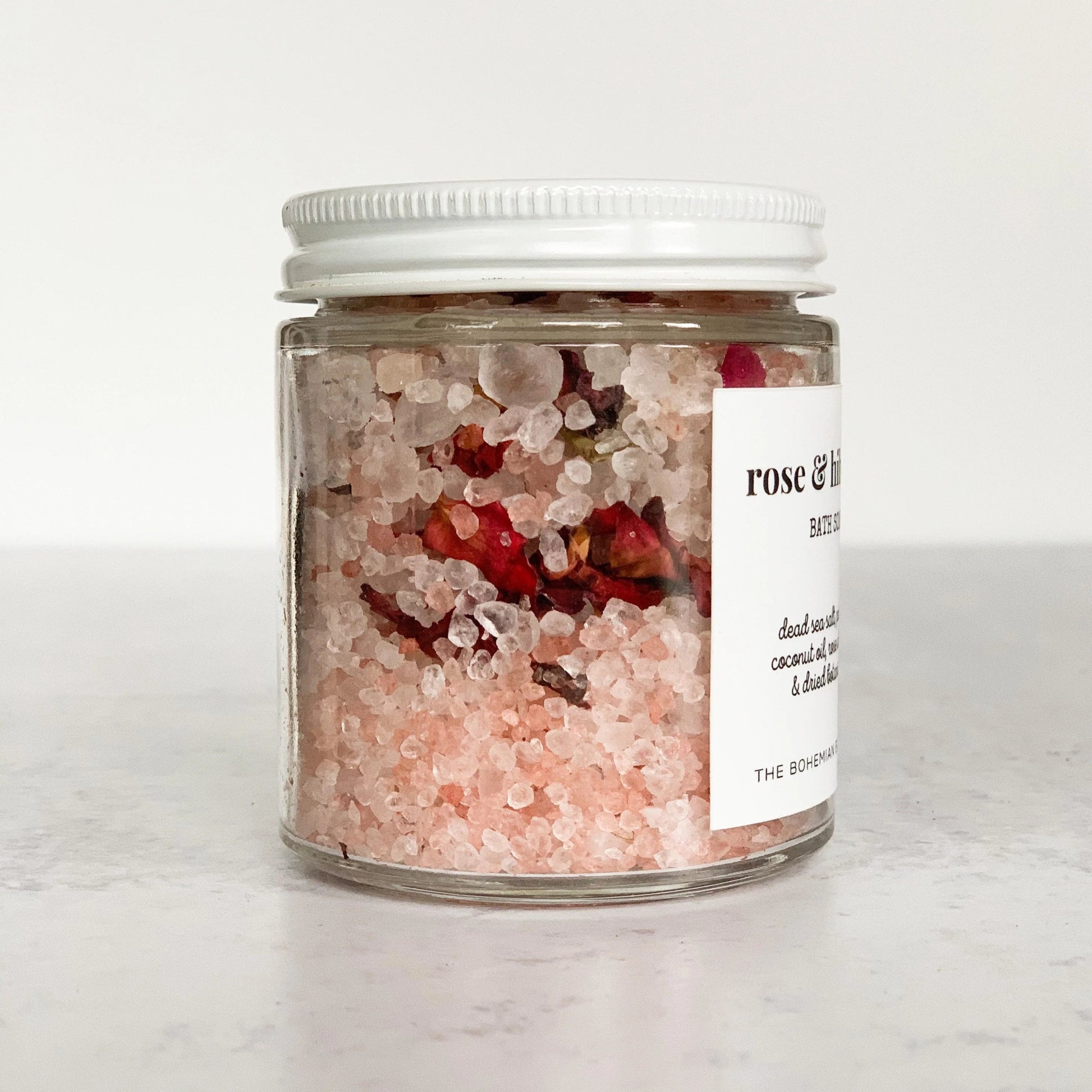 Rose and Hibiscus Bath Soak in a clear glass jar with white lid