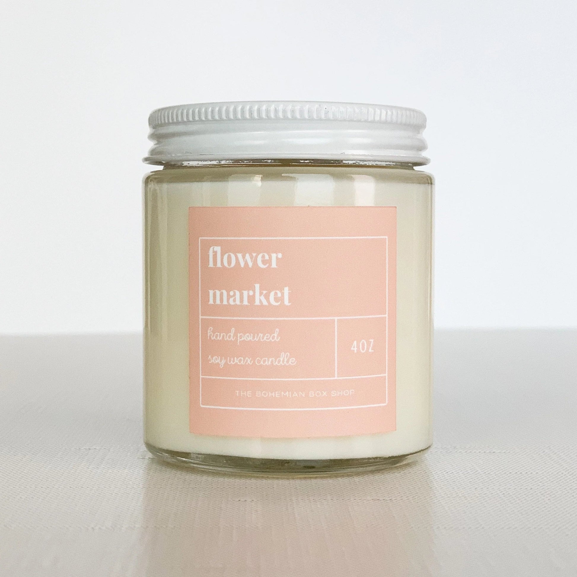 Flower Market 4oz Soy Candle in a clear glass jar, white lid and blush pink label