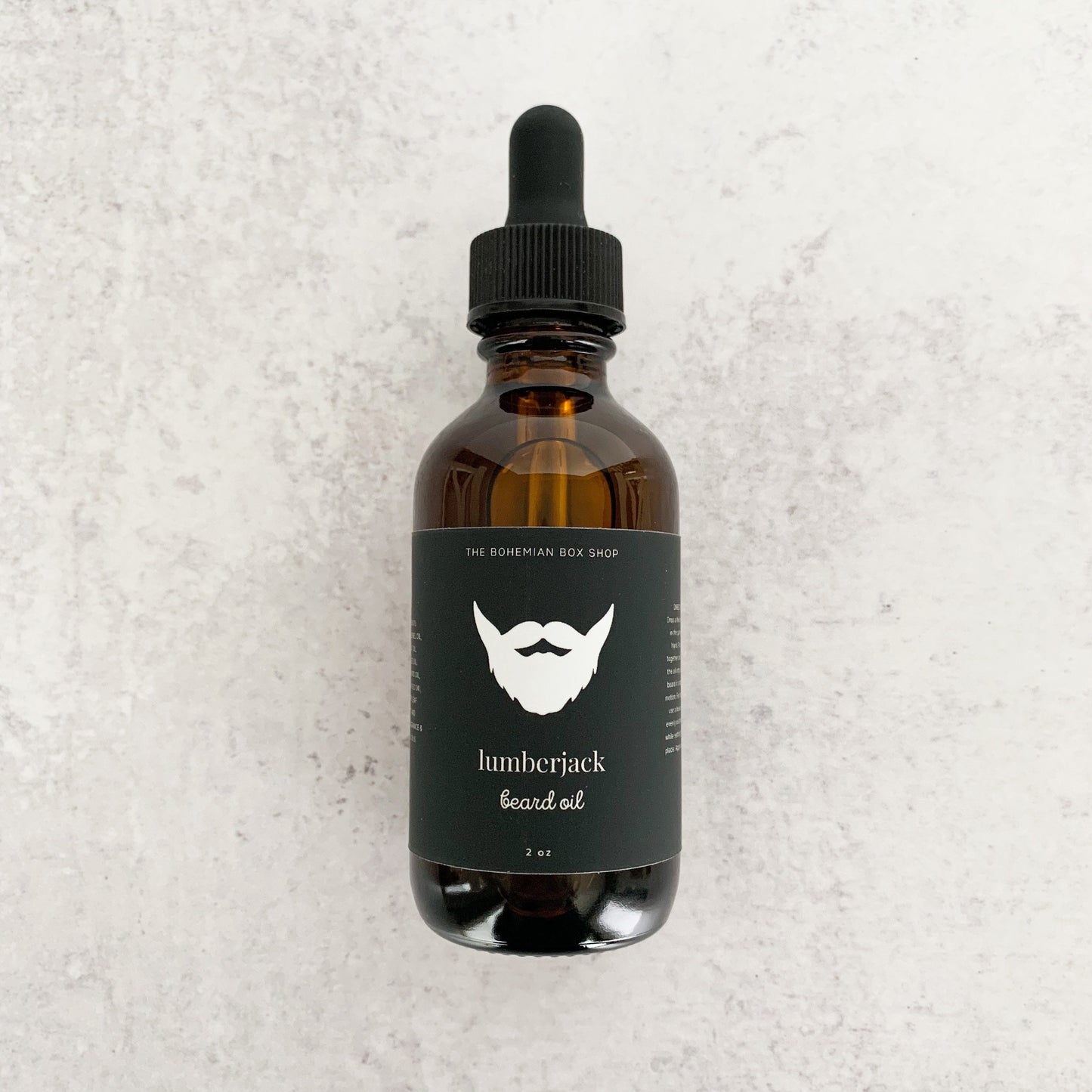 lumberjack beard oil in an amber colored bottle with black dropper