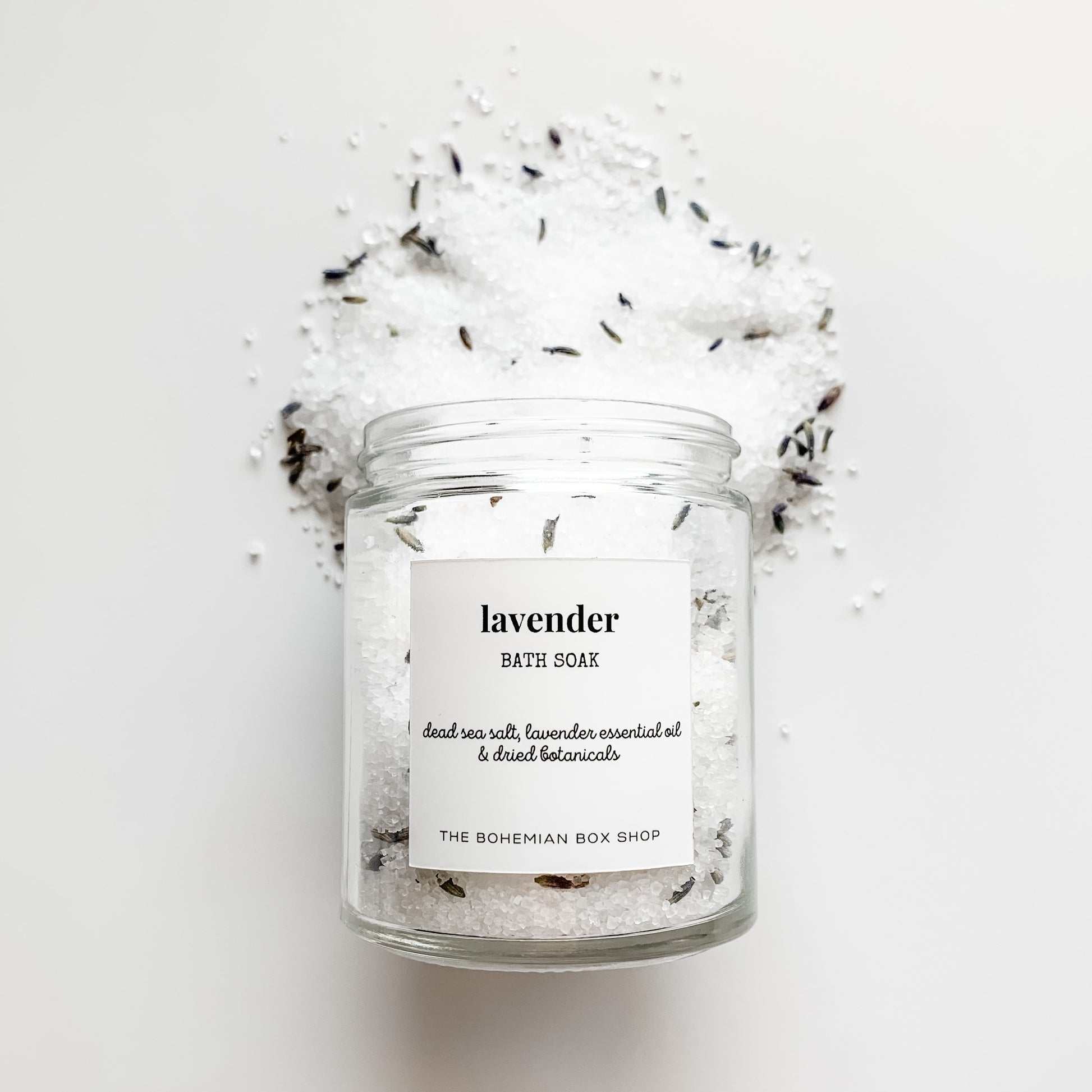 Lavender Bath Soak in a clear glass jar with white label 
