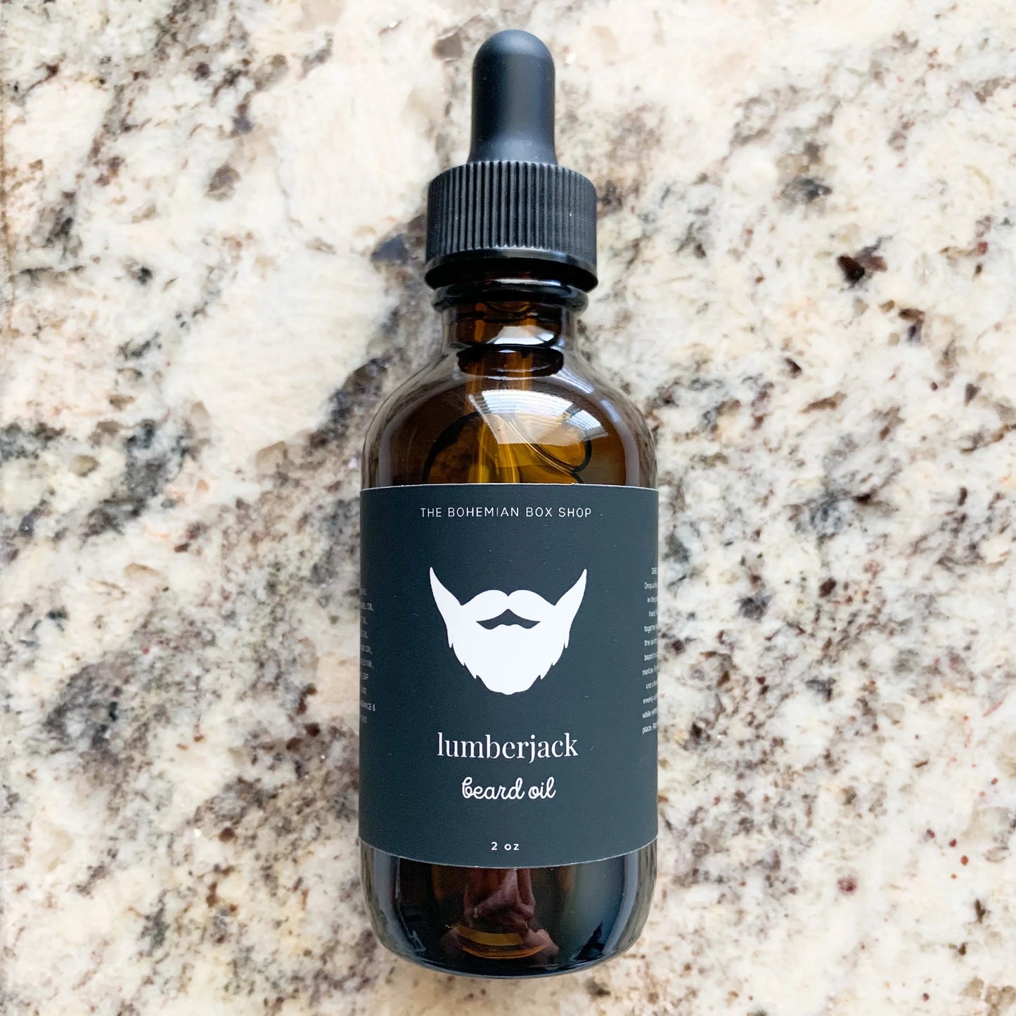 lumberjack beard oil in an amber colored bottle with black dropper