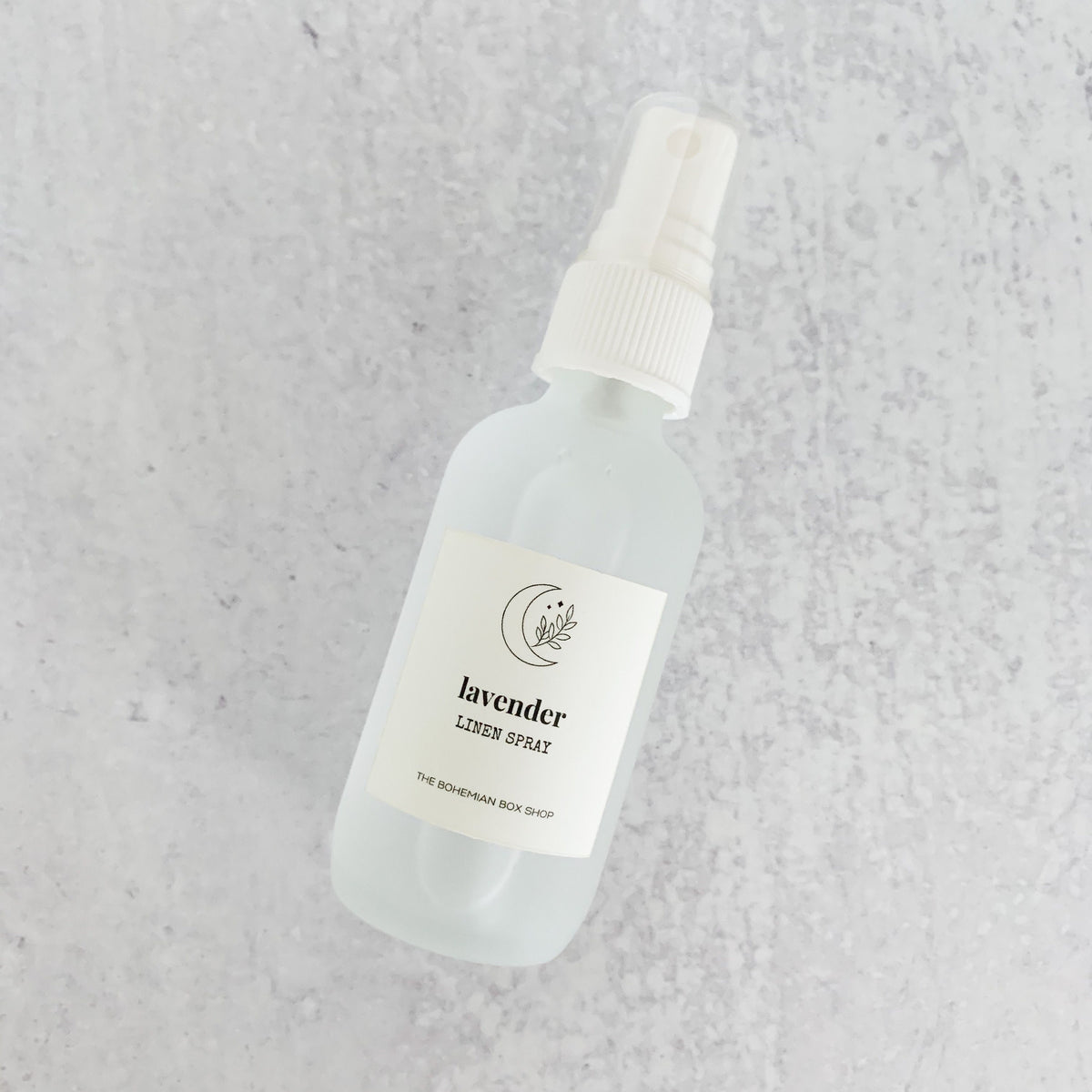 lavender linen spray in a frosted glass bottle