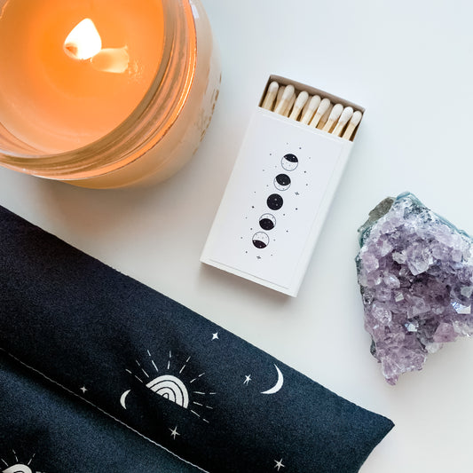 moon phase boho style matches with a candle lit in the background and an amethyst stone